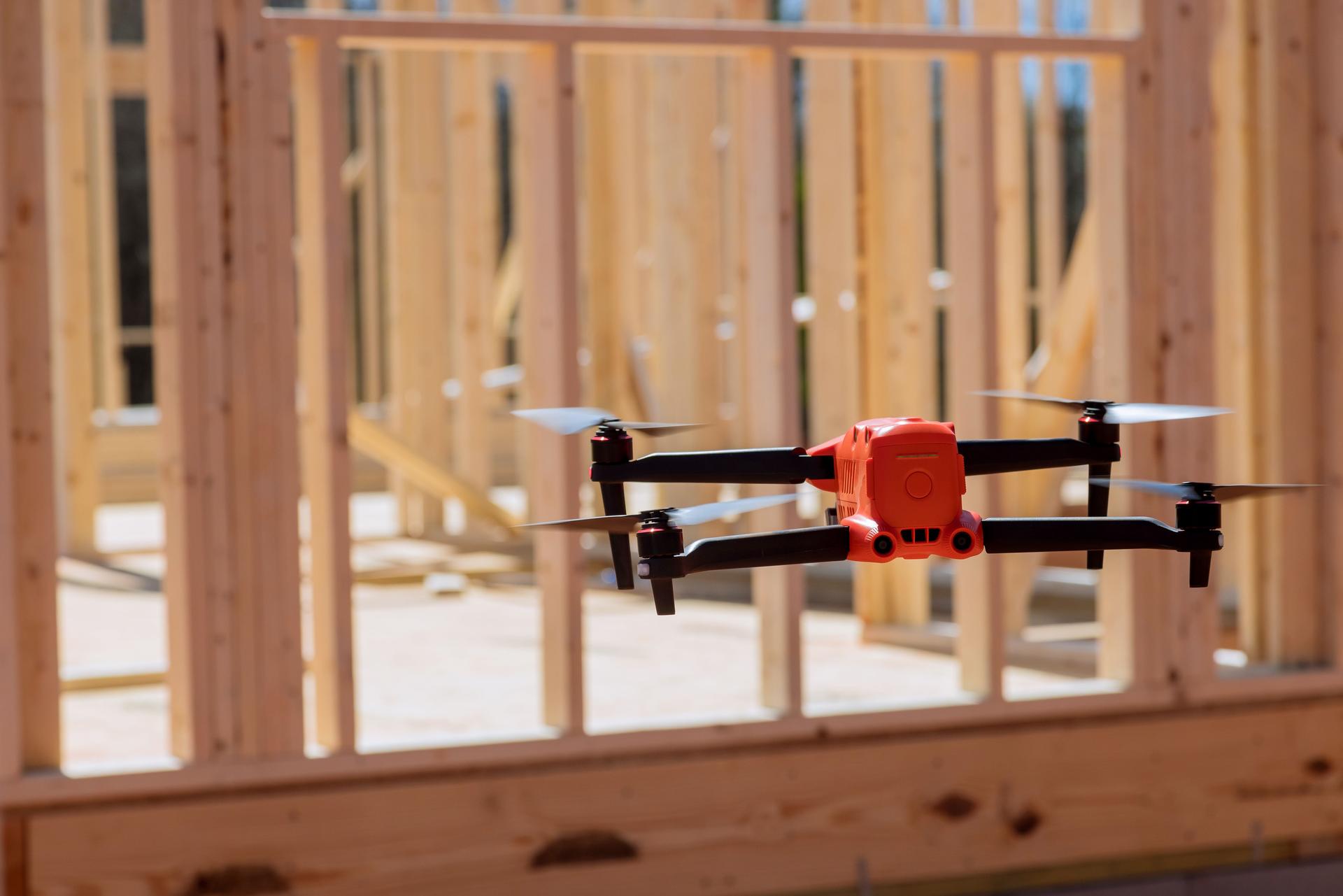 A construction inspector checks quality of construction work by using a drone on the construction site